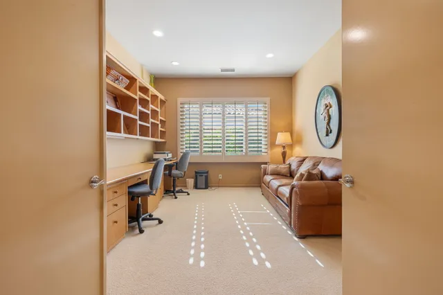 a view of a chairs and table in patio with a lake view