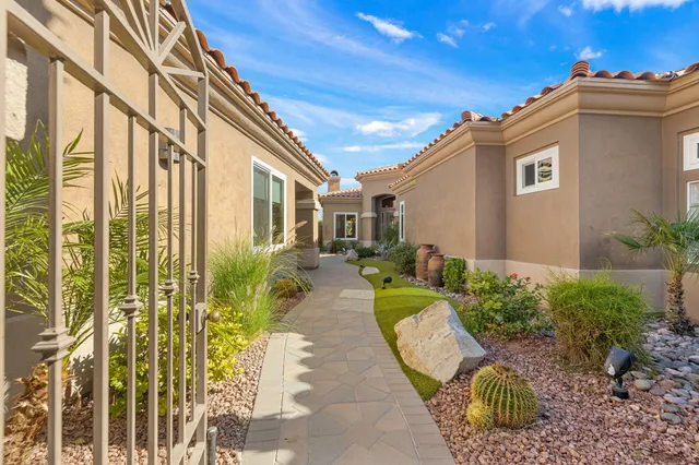 a view of a hallway with dining area and chandelier