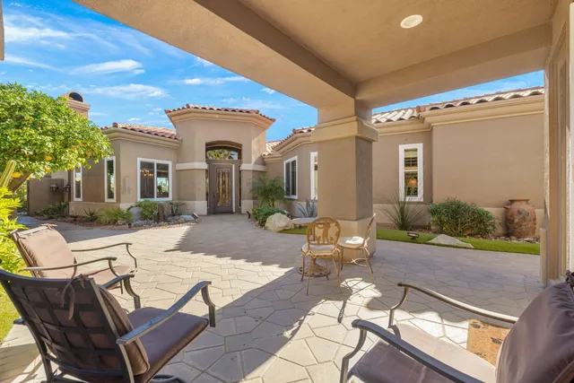 a living room with furniture flat screen tv and large window