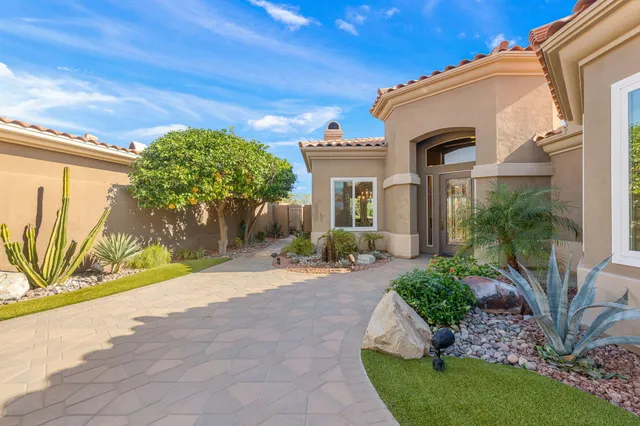 a living room with furniture and a view of kitchen