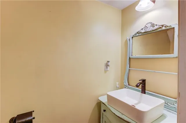 a bathroom with a sink a toilet and mirror