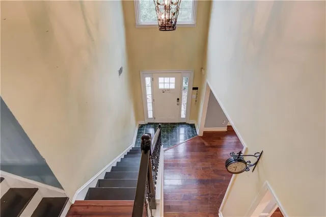 a view of a hallway with wooden floor and staircase