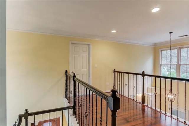 a view of hallway with wooden floor