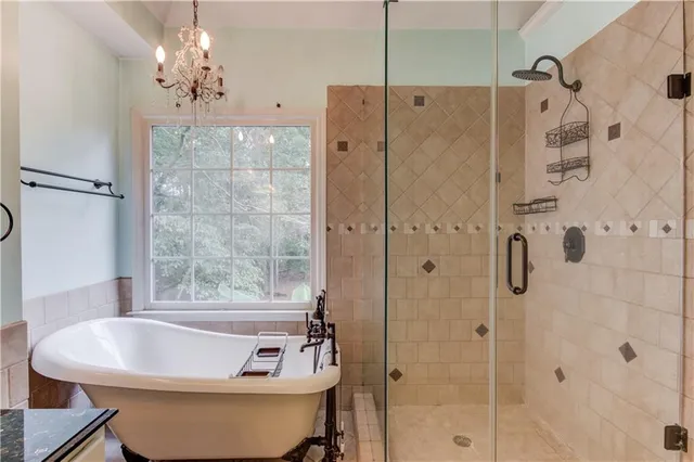 a white bath tub sitting next to a shower