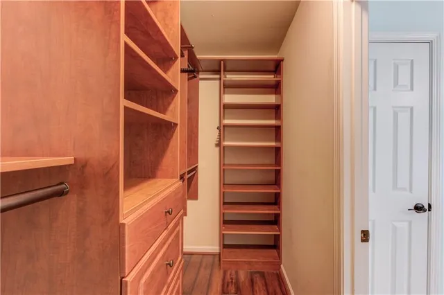 a view of walk in closet with empty racks