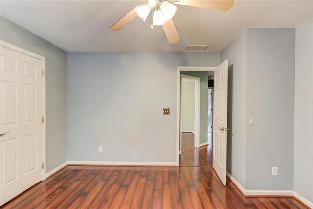 a view of a room with wooden floor and a window