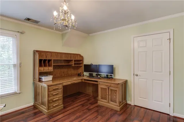 a kitchen with stainless steel appliances a stove and a chandelier