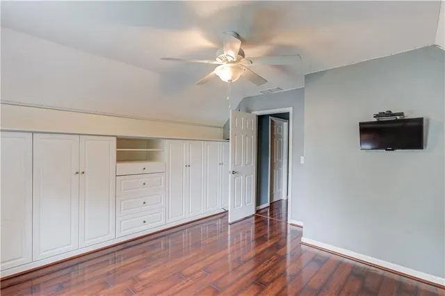 a view of an empty room and wooden floor