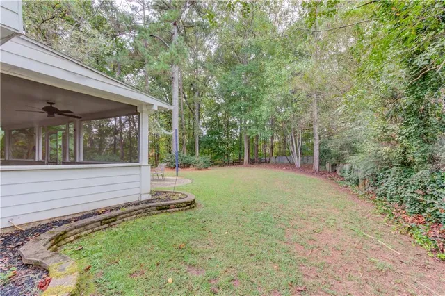 a view of a backyard with large trees