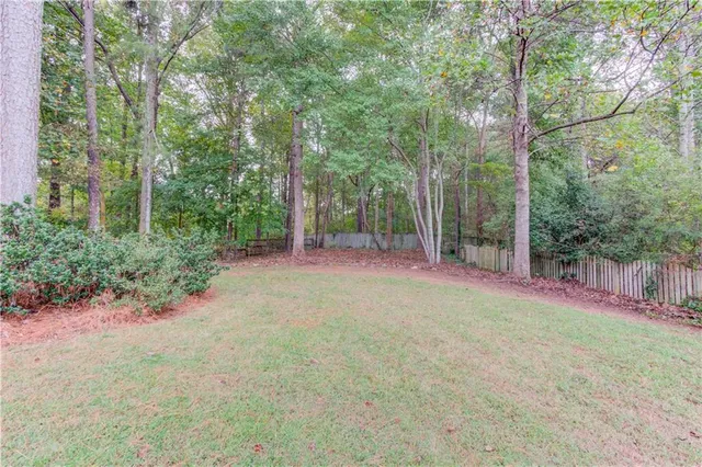 a view of a field with trees in the background