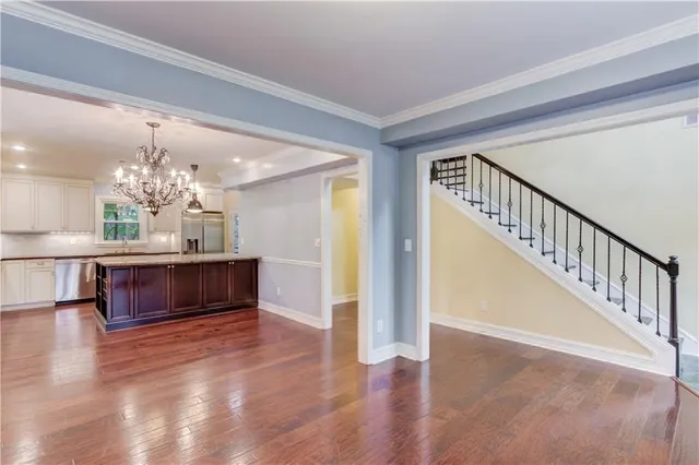 a view of kitchen and hall with wooden floor