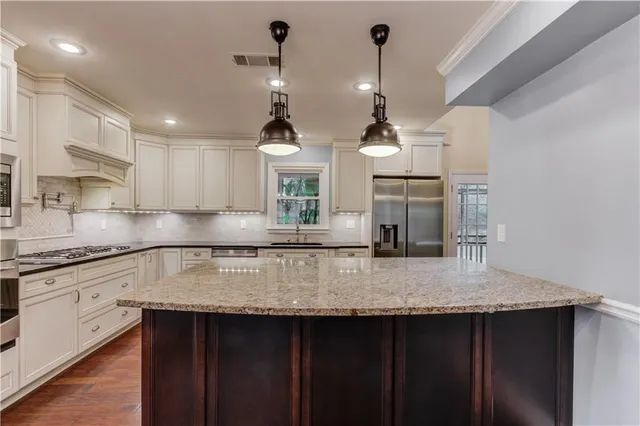 a kitchen with kitchen island granite countertop a sink and center island
