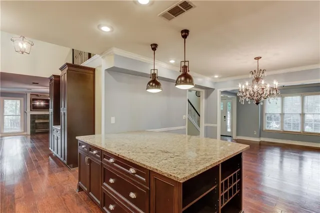 an open kitchen with sink and refrigerator