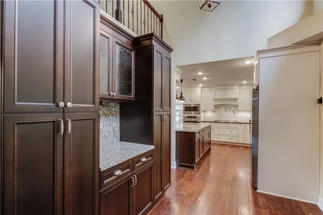 a kitchen with kitchen island white cabinets and stainless steel appliances