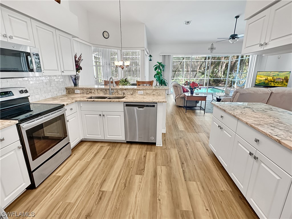 a kitchen with a sink stove and cabinets
