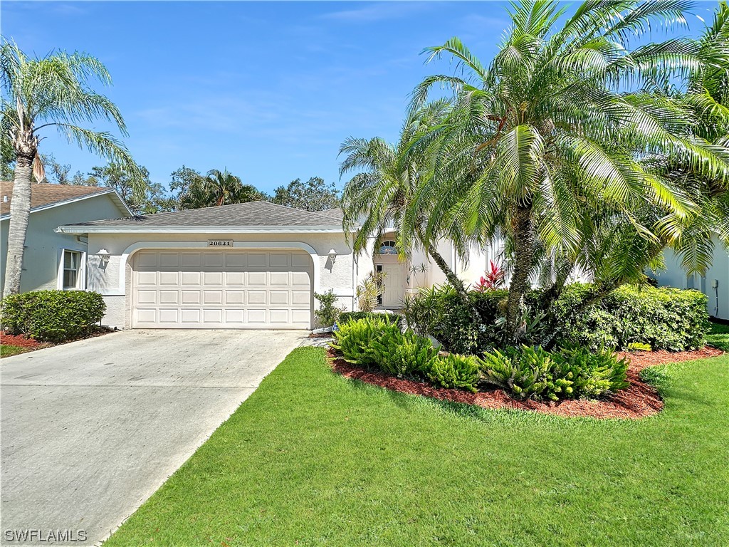 20631 Rivers Ford Estero, FL 33928 - Photo 17 of 18 a front view of a house with a garden and yard