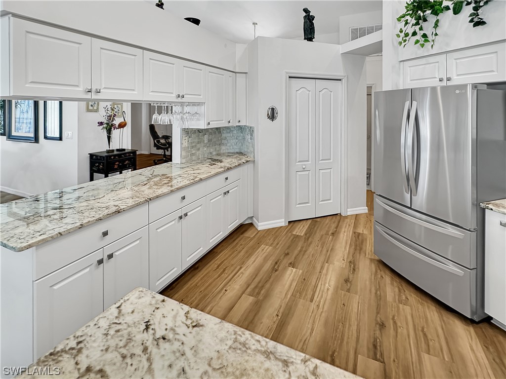 20631 Rivers Ford Estero, FL 33928 - Photo 3 of 18 a kitchen with stainless steel appliances kitchen island granite countertop a refrigerator and microwave