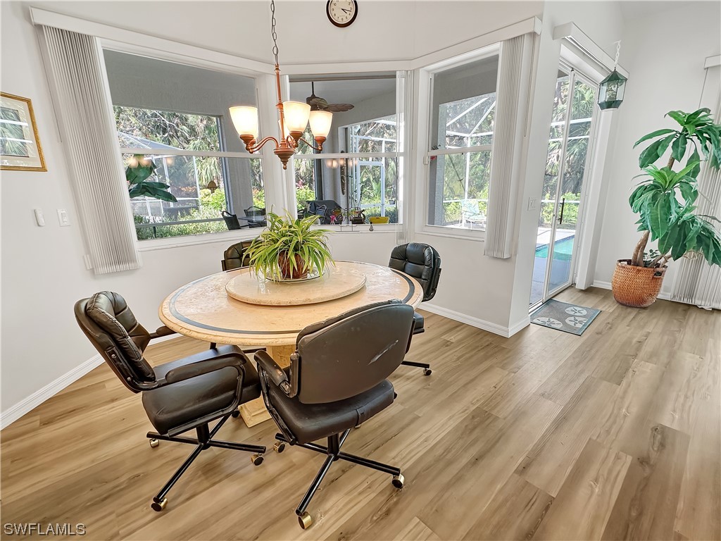 20631 Rivers Ford Estero, FL 33928 - Photo 8 of 18 a dining room with furniture a chandelier and wooden floor