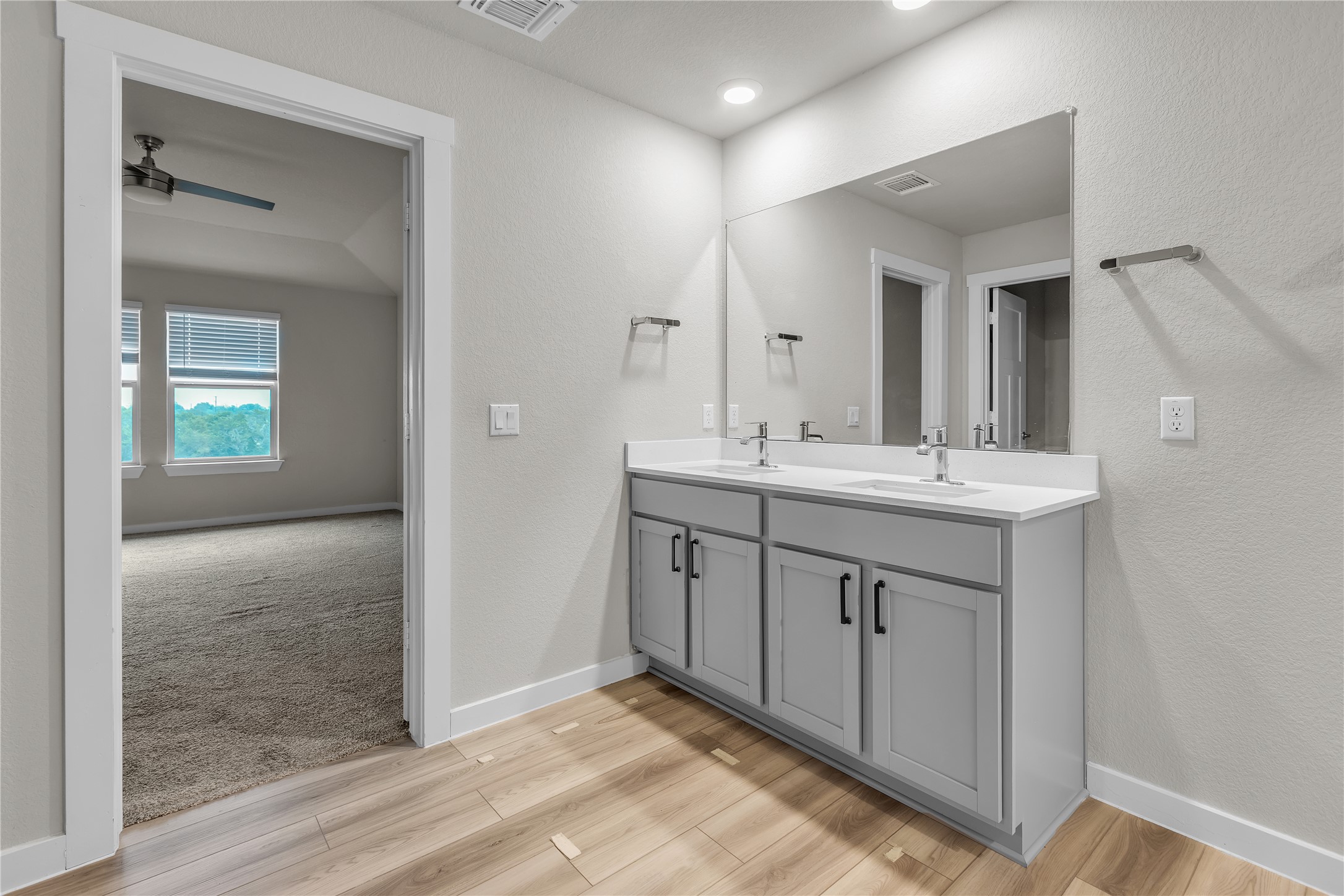 1212 Tipton Street Georgetown, TX 78633 - Photo 11 of 20 Double vanity in a primary bathroom with modern fixtures and a large mirror.