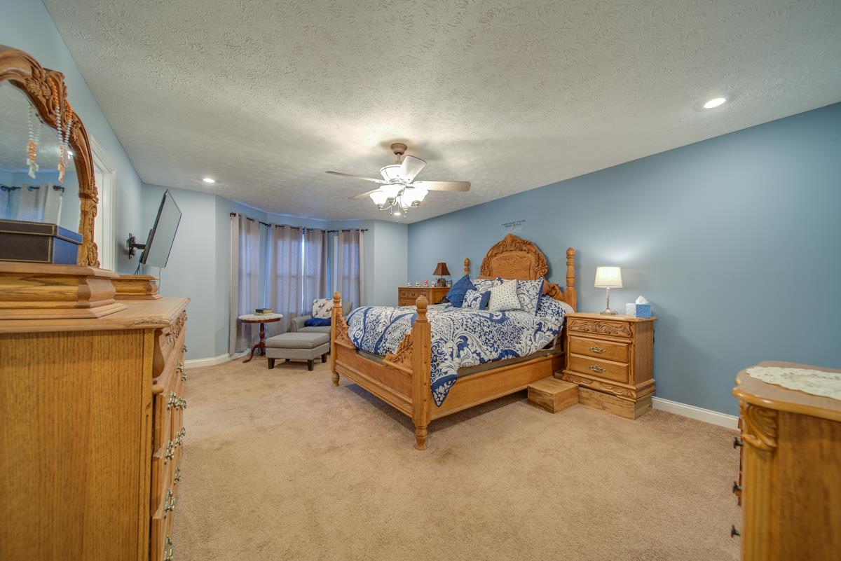 1200 Hollis Chapel Road Portland, TN 37148 - Photo 13 of 22 a bed room with a bed and a chandelier