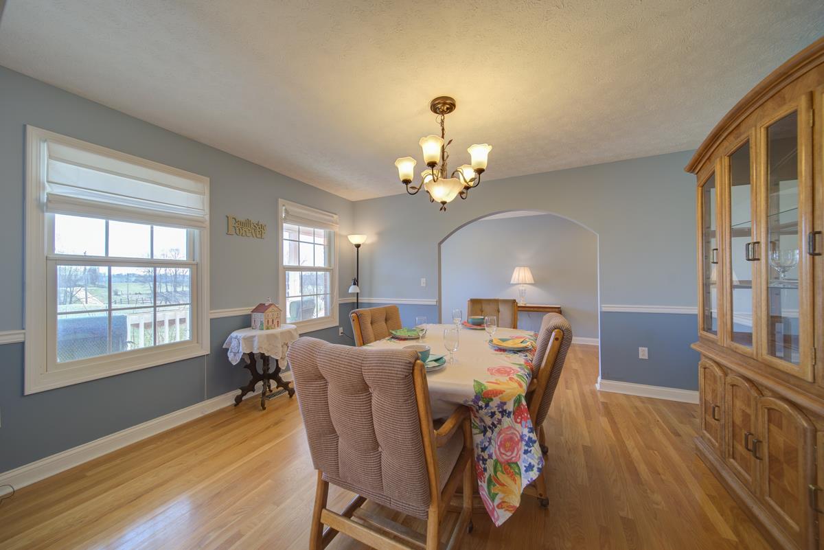 1200 Hollis Chapel Road Portland, TN 37148 - Photo 3 of 22 a view of a dining room with furniture a chandelier and wooden floor