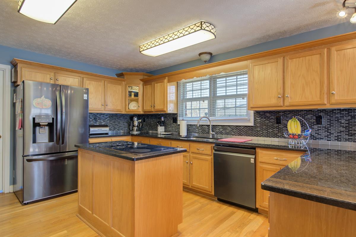 1200 Hollis Chapel Road Portland, TN 37148 - Photo 5 of 22 a kitchen with stainless steel appliances granite countertop a sink stove and refrigerator