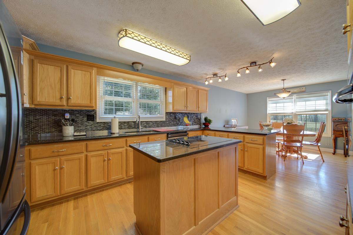 1200 Hollis Chapel Road Portland, TN 37148 - Photo 6 of 22 a kitchen with stainless steel appliances granite countertop a sink a stove and a refrigerator