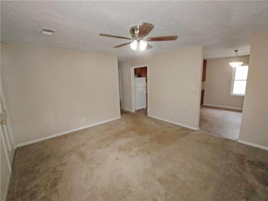 497 Highway 212 Covington, GA 30016 - Photo 3 of 14 a view of an empty room and a ceiling fan