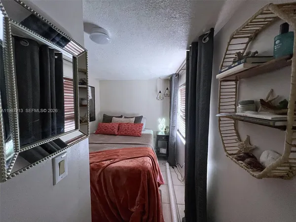 a bed room with a bed and a television