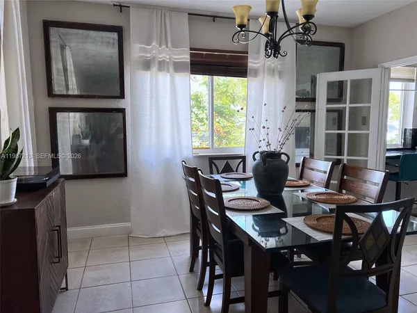 a dining room with furniture and window