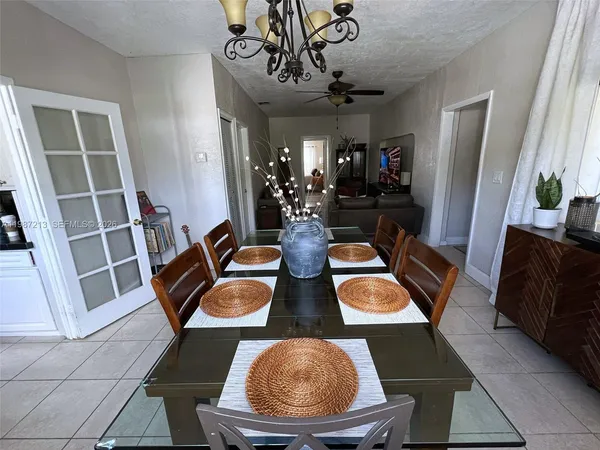 a view of a dining room with furniture and a chandelier