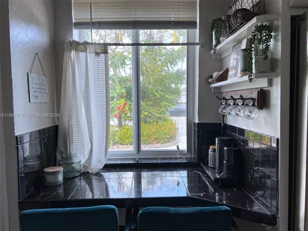a living room with fireplace furniture and a floor to ceiling window