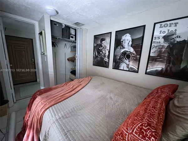 a bedroom with a bed and a walk in closet