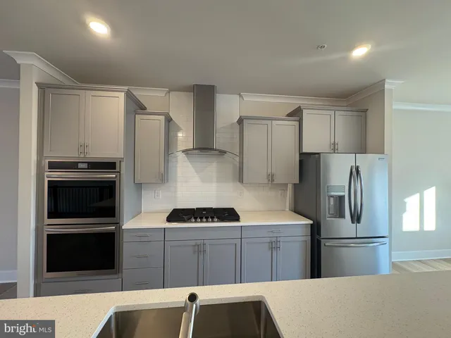 a kitchen with a refrigerator and a stove
