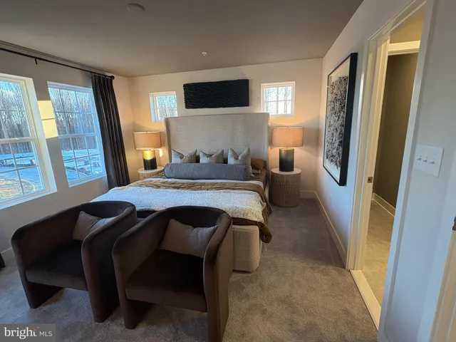 a bedroom with a bed and a flat tv screen on dresser