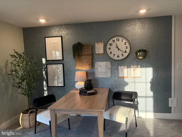a view of a dining area with furniture and a large window