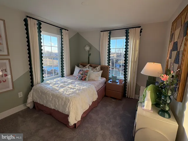 a spacious bedroom with a bed and a potted plant