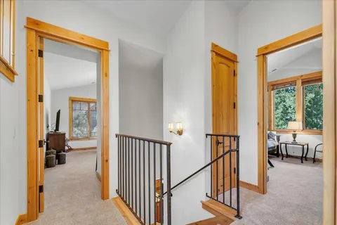 a bedroom with a bed and a large window