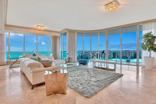 a living room with furniture and a floor to ceiling window