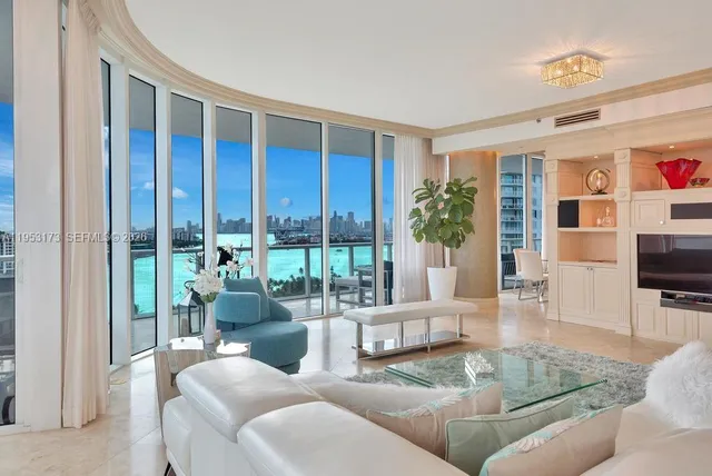 a living room with furniture and a floor to ceiling window