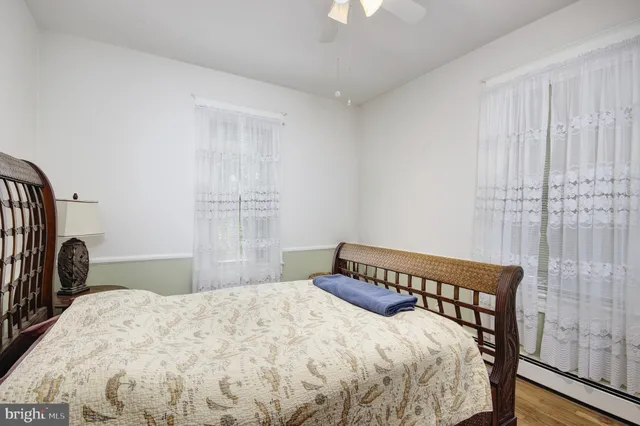 a view of a workspace with furniture and wooden floor
