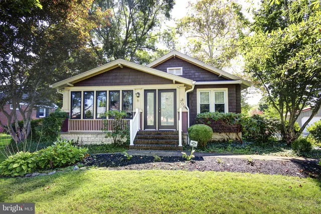 a front view of a house with yard and green space