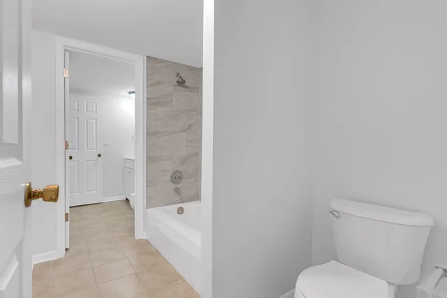 a bathroom with a toilet and shower