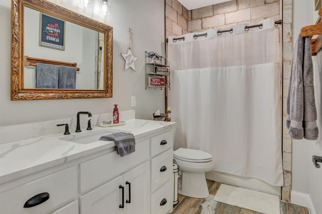129 Whiskey Rnch Road Runaway Bay, TX 76426 - Photo 28 of 39 a bathroom with a sink toilet and shower