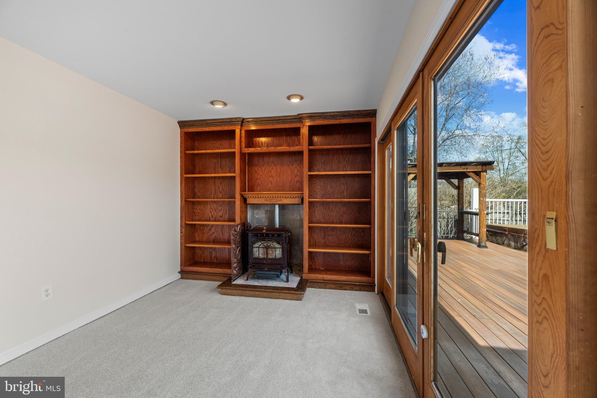 5929 Deale Beach Road Deale, MD 20751 - Photo 17 of 58 Unfurnished living room with a wood stove, light c