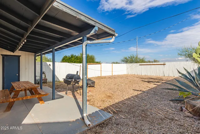 a view of a patio with a table and chairs