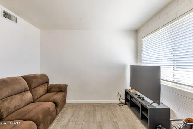 a bedroom with furniture and a window