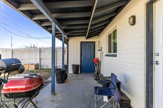 a view of a house with a wooden fence