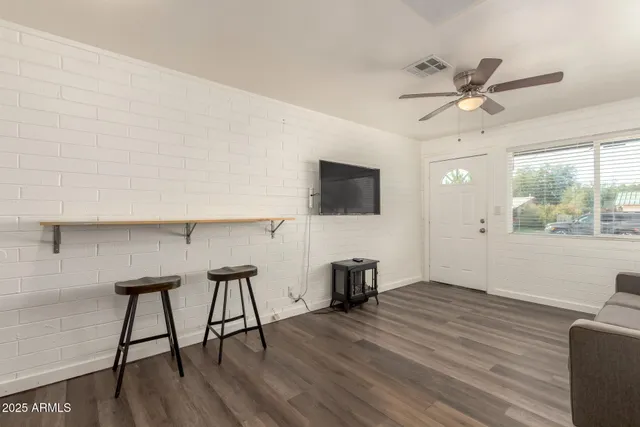 a view of a livingroom with furniture and a flat screen tv