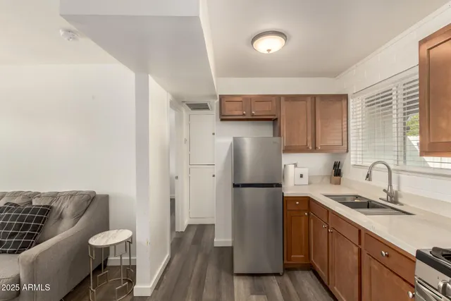 a kitchen with a refrigerator and a sink
